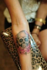 Female arm colored skull and flower tattoo pattern