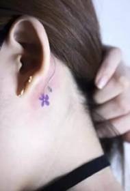 a nice-looking tattoo pattern behind the girl's ear