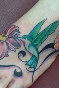 girl's instep colored hummingbird and flower tattoo pattern