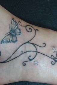 Stiklinis drugelio vynmedis su tatuiruotės raštu