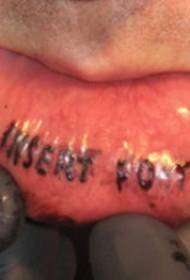 black inscription letters tattoo inside the lips