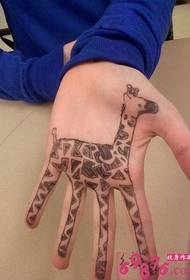 cartoon giraffe palm tattoo