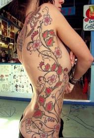 orientalisk super sexig skönhet kvinnlig i sidled blomma vinstock tatuering Bild