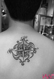 man with black and white compass tattoo on the back
