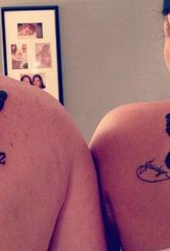 stylish couple shoulder English tattoos