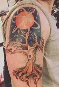Tatuaggio a braccio colorato con piccolo universo e rami secchi