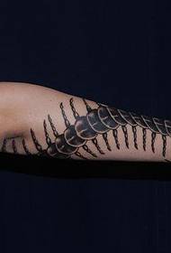 a long skull tattoo on the arm