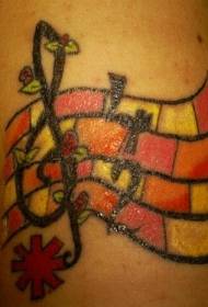 Braccio note musicali colorate e motivo tatuaggio rosa