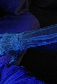 Skeleton fluorescent tattoo pattern on the arm