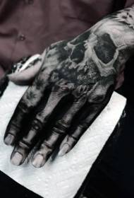 Creepy mustavalkoinen kallon luuranko tatuointi käden takana