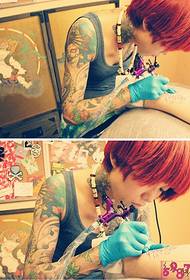 Beautiful tattoo artist creates tattoo scene