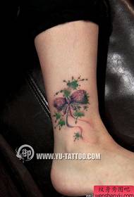 Beautiful female legs with realistic realistic bow tattoo