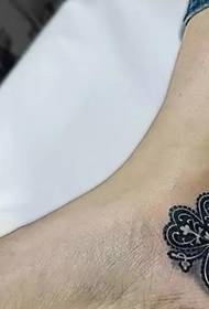 Romantikong at mapalad na apat na dahon na klouber na tattoo