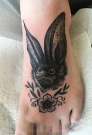 Black sketch rabbit and flower tattoo picture on girl's instep