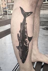 a black shark tattoo pattern on the calf