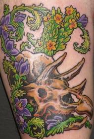 Crani de dinosaure i patró de tatuatges de flors vegetals