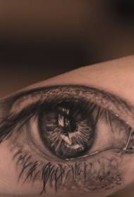Braccio surreale modello umano tatuaggio occhio grigio nero