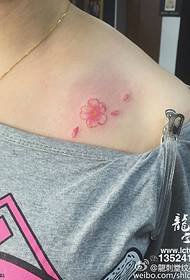 Beautiful small cherry blossom tattoo on the shoulder