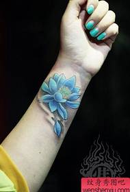 Girl's wrist, nice blue lotus tattoo pattern
