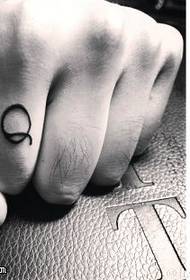 Q character tattoo pattern on the finger