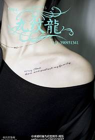 Small character tattoo pattern at the collarbone