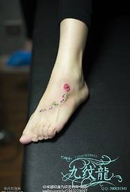 a fresh flower tattoo on the foot