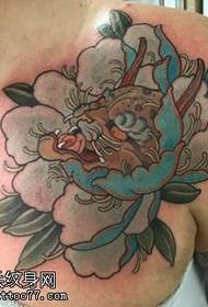 peony-like tattoo pattern on the shoulder