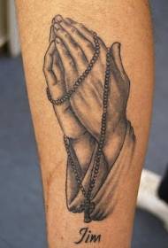 arm svart grå bön hand och radband tatuering bild