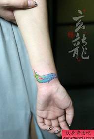 Zglobovi djevojaka su mali i lijepo obojeni dizajni perja tetovaža
