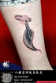 girls legs Department of a pin and wings tattoo pattern