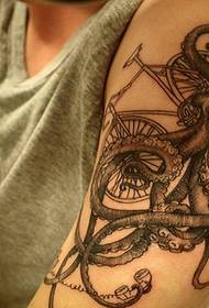 малюнок татуювання великих восьминога та велосипеда на великій руці