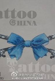 Delicate blue bow tattoo pattern