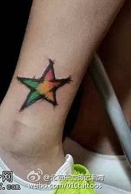 Watercolor five-pointed star tattoo on ankle