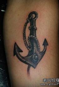 Arm of a black gray anchor tattoo pattern