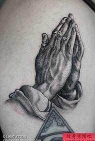 A classic popular prayer hand tattoo pattern