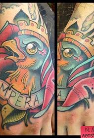 a school-style bird tattoo on the back of the hand