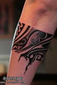 arms with a totem tattoo pattern