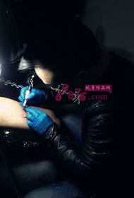 boy's arm black ash tattoo scene