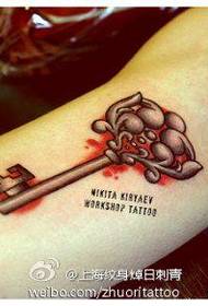 piccolo tatuaggio chiave all'interno del braccio