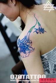 a popular trumpet tattoo on the shoulder of a beautiful woman