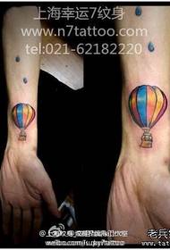 small colored hot air balloon tattoo pattern at the wrist