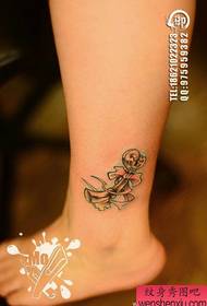 girl Legs are popular with a small key tattoo pattern