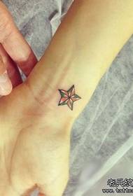 djevojčino zglobovo na uzorku male tetovaže pentagrama