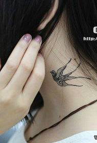 a nice totem swallow tattoo pattern at the girl's neck