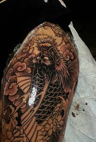 black and white evil dragon tattoo pattern covering the entire thigh