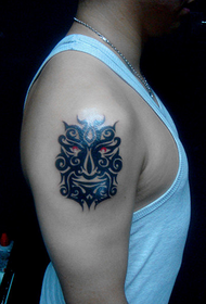 arm totem mask tattoo