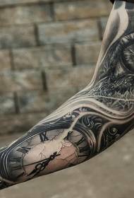 clock and eyeball combined flower arm tattoo picture