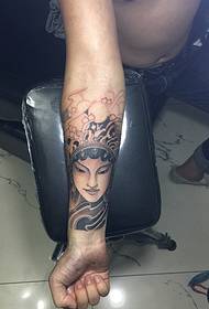 There is a small flower tattoo on the arm