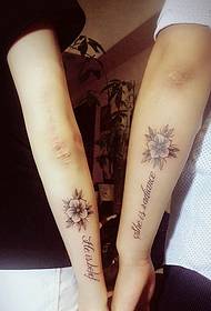 Arm utenfor det engelske og blomsterparet tatovering